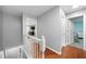 Well-lit hallway with hardwood floors, leading to several rooms at 1630 Marsanne Nw Ter # 27, Kennesaw, GA 30152
