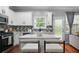 Bright, updated kitchen with white cabinets, quartz countertops, and stainless steel appliances at 1630 Marsanne Nw Ter # 27, Kennesaw, GA 30152