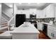 Modern kitchen features stainless steel appliances, white cabinetry, and quartz countertops at 1630 Marsanne Nw Ter # 27, Kennesaw, GA 30152