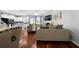 Cozy living room featuring hardwood floors, comfortable sofas, a fireplace, and open access to the kitchen at 1630 Marsanne Nw Ter # 27, Kennesaw, GA 30152