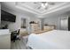 The main bedroom features a decorative headboard, tv, desk, ensuite bathroom and walk in closet at 1630 Marsanne Nw Ter # 27, Kennesaw, GA 30152