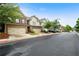 Street view of townhomes with two-car garages and well-kept lawns, set against a bright sky at 1630 Marsanne Nw Ter # 27, Kennesaw, GA 30152