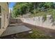 The backyard features a patio, privacy fence, rock details and lush green moss at 4139 Magnolia Glen Walk, Norcross, GA 30093