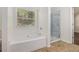 Bathroom featuring large soaking tub next to a glass enclosed shower at 4139 Magnolia Glen Walk, Norcross, GA 30093