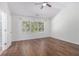 Bedroom featuring large window, vaulted ceiling, and hardwood floors at 4139 Magnolia Glen Walk, Norcross, GA 30093
