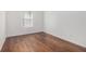 Bedroom featuring hardwood floors, baseboard trim and window with blinds at 4139 Magnolia Glen Walk, Norcross, GA 30093