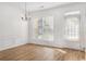 Bright dining area featuring hardwood floors, decorative trim, and a chandelier at 4139 Magnolia Glen Walk, Norcross, GA 30093