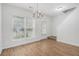 Well-lit dining room featuring hardwood floors, modern chandelier, and staircase access at 4139 Magnolia Glen Walk, Norcross, GA 30093