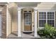 Inviting front entryway featuring a classic door, decorative columns, and lush greenery at 4139 Magnolia Glen Walk, Norcross, GA 30093