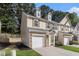 Side view of an appealing townhouse with a garage, lawn, and traditional design at 4139 Magnolia Glen Walk, Norcross, GA 30093