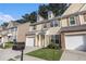 Welcoming townhouse boasts a well-kept lawn, attached garage, and appealing facade at 4139 Magnolia Glen Walk, Norcross, GA 30093