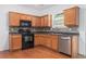 Modern kitchen equipped with stainless steel appliances and plenty of wood cabinet storage at 4139 Magnolia Glen Walk, Norcross, GA 30093