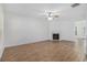 Spacious living room featuring wood floors, ceiling fan, and a fireplace for cozy evenings at 4139 Magnolia Glen Walk, Norcross, GA 30093