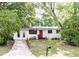 Charming single-story home featuring a bright red front door and a neatly maintained front lawn at 5904 Heatherwood Ln, Riverdale, GA 30296