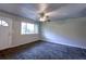 Inviting living room featuring plush gray carpeting, a ceiling fan, and a bright window offering ample natural light at 5904 Heatherwood Ln, Riverdale, GA 30296