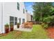 Backyard featuring outdoor seating, a lush green lawn, and well-maintained landscaping at 867 Crested Hawk Trl, Sugar Hill, GA 30518