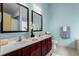 Bright bathroom with double vanity, framed mirrors, and stylish fixtures at 867 Crested Hawk Trl, Sugar Hill, GA 30518