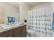 Stylish bathroom with marble countertop vanity and decorative shower curtain at 867 Crested Hawk Trl, Sugar Hill, GA 30518