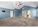 Spacious bedroom with vaulted ceiling, ceiling fan, and access to the ensuite bathroom and closet at 867 Crested Hawk Trl, Sugar Hill, GA 30518