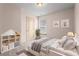 Neat bedroom featuring a bed, window, and charming decor at 867 Crested Hawk Trl, Sugar Hill, GA 30518