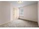 Neutral bedroom featuring carpet, a window with blinds, and a closet at 867 Crested Hawk Trl, Sugar Hill, GA 30518