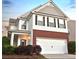Charming two-story home with a brick and vinyl exterior, complemented by a two-car garage and well-maintained landscaping at 867 Crested Hawk Trl, Sugar Hill, GA 30518