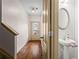 Hallway features a staircase and a stylish powder room with a pedestal sink, offering convenience and charm at 867 Crested Hawk Trl, Sugar Hill, GA 30518