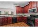 Beautiful kitchen featuring stainless steel appliances, dark cabinetry, and sleek countertops at 867 Crested Hawk Trl, Sugar Hill, GA 30518