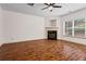 Bright living room featuring a fireplace, hardwood floors, and a large window at 867 Crested Hawk Trl, Sugar Hill, GA 30518