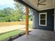 Covered back porch with ceiling fan, stylish post supports, and a view of the backyard at 1197 Avondale Se Ave, Atlanta, GA 30312