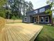A newly constructed home featuring a spacious wooden backyard deck for outdoor entertaining at 1197 Avondale Se Ave, Atlanta, GA 30312