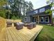 Wooden deck with patio seating, grill, and manicured lawn in a fully fenced backyard at 1197 Avondale Se Ave, Atlanta, GA 30312
