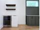 Stylish bar area with wine fridge, custom cabinetry, and floating wine racks at 1197 Avondale Se Ave, Atlanta, GA 30312