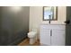 Modern half bathroom featuring a sleek vanity with white countertops and black hardware at 1197 Avondale Se Ave, Atlanta, GA 30312