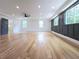 Spacious bedroom featuring light wood floors, large windows, recessed lighting, and stylish paneled accent wall at 1197 Avondale Se Ave, Atlanta, GA 30312