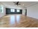 Spacious bedroom with elegant hardwood floors, stylish dark accent wall with windows, and a modern ceiling fan at 1197 Avondale Se Ave, Atlanta, GA 30312