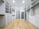 Large walk-in closet with custom shelving, drawers, and light hardwood floors, maximizing organization at 1197 Avondale Se Ave, Atlanta, GA 30312