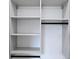 Organized walk-in closet with custom white shelving and black hardware for hanging clothes at 1197 Avondale Se Ave, Atlanta, GA 30312