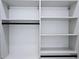 Organized walk-in closet with custom white shelving and black hardware for hanging clothes at 1197 Avondale Se Ave, Atlanta, GA 30312