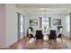 Elegant dining room with a glass-top table, seating for six, and modern lighting at 1197 Avondale Se Ave, Atlanta, GA 30312