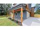 Stylish home featuring a covered porch with wood columns, integrated lighting, and an attached garage at 1197 Avondale Se Ave, Atlanta, GA 30312