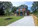 Beautiful three-story home with a spacious driveway, lush green lawn, and contemporary wood and gray exterior at 1197 Avondale Se Ave, Atlanta, GA 30312