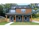 Charming new construction home featuring a covered porch with striking wood columns and a combination of grey and wood siding at 1197 Avondale Se Ave, Atlanta, GA 30312