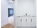 Hallway wet bar with stone countertop and dark hardware at 1197 Avondale Se Ave, Atlanta, GA 30312