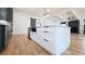 Modern kitchen with large island, stainless steel appliances, hardwood floors, and designer lighting at 1197 Avondale Se Ave, Atlanta, GA 30312