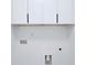 White laundry room cabinets and tiled floor, hookups visible at 1197 Avondale Se Ave, Atlanta, GA 30312