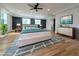 Spacious main bedroom with hardwood floors, recessed lighting, dark accent wall, and a view of the backyard at 1197 Avondale Se Ave, Atlanta, GA 30312