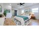 Bright main bedroom featuring hardwood floors, a ceiling fan, natural light, and an ensuite bathroom entrance at 1197 Avondale Se Ave, Atlanta, GA 30312