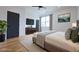 Bright main bedroom featuring hardwood floors, a ceiling fan, natural light, and an ensuite bathroom entrance at 1197 Avondale Se Ave, Atlanta, GA 30312