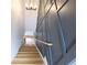 Unique stairway design highlighted by geometric wall paneling and wooden handrail at 1197 Avondale Se Ave, Atlanta, GA 30312